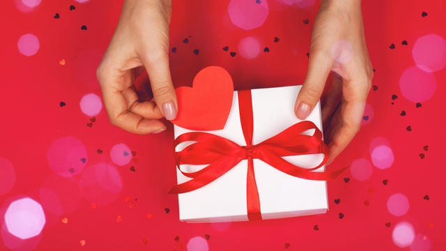 Beautiful female hand with packaged cute gift 