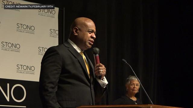 Newark Mayor Ras J. Baraka speaks on stage. 