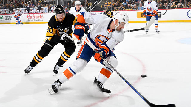Adam Pelech #3 of the New York Islanders battles against Lars Eller #20 of the Pittsburgh Penguins at PPG PAINTS Arena on February 20, 2024 in Pittsburgh, Pennsylvania. 