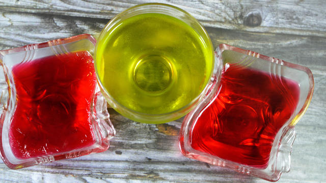 Delicious sweet green and red jelly pudding pineapple and strawberry flavored, chilled green and red jelly dessert, Gelatin desserts (also Jelly or Jello), a sweetened and flavoured 