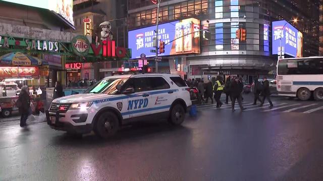 An NYPD vehicle parked on a street corner near Times Square. 