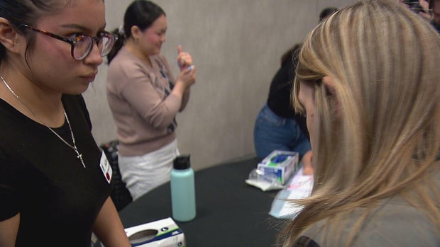 A student is speaking with her instructor during her work based learning experience