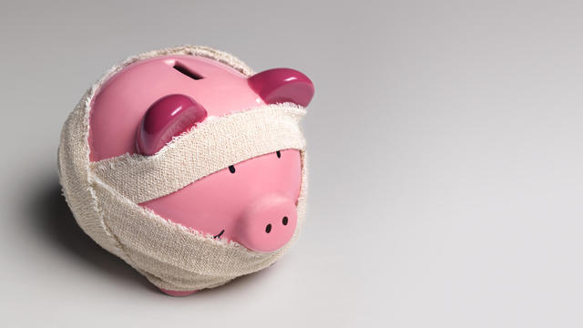Ill piggy bank with bandages 