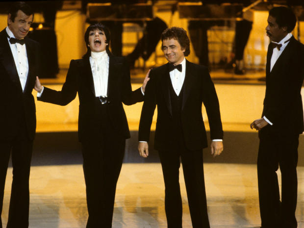 From left, Walter Matthau, Liza Minnelli, Dudley Moore and Richard Pryor are seen hosting the Academy Awards, April 11, 1983. 