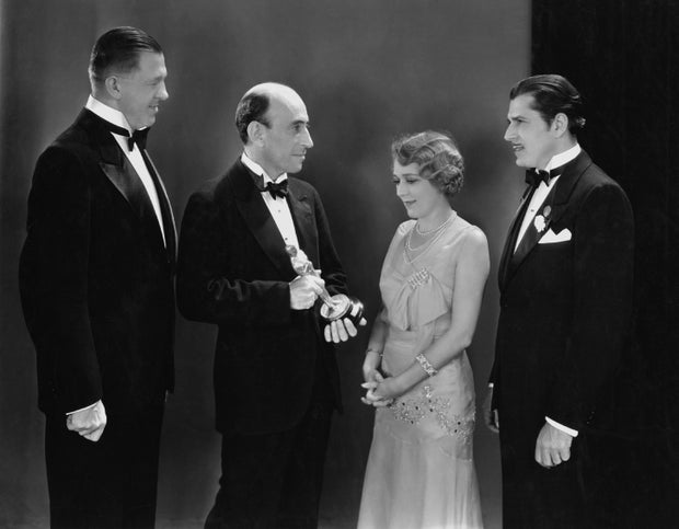 From left, Hans Kraly, winner of the Academy Award for writing; academy President William C. DeMille; best actress winner Mary Pickford; and best actor winner Warner Baxter are seen at the Oscars in Hollywood, California, April 3, 1930.