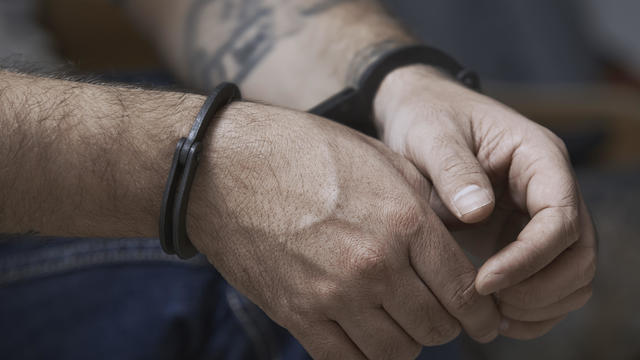 Cropped image of criminal in handcuffs 