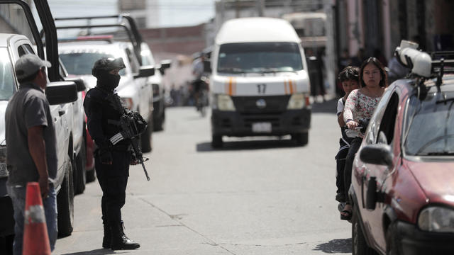 Police officers guard the scene where mayoral candidate Armando Perez Luna was killed, in Maravatio 
