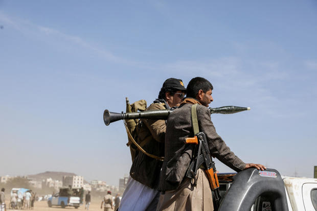 Armed Houthi followers ride on the back of a pickup truck during a parade in solidarity with the Palestinians in the Gaza Strip and to show support to Houthi strikes on ships in the Red Sea and the Gulf of Aden, in Sanaa, Yemen, Jan. 29, 2024. 
