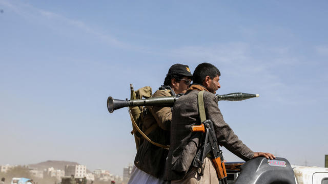 Armed Houthi followers ride on the back of a pickup truck during a parade in solidarity with the Palestinians in the Gaza Strip and to show support to Houthi strikes on ships in the Red Sea and the Gulf of Aden, in Sanaa, Yemen, Jan. 29, 2024. 