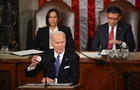 President Biden holds a button with Laken Riley's name on it while delivering the State of the Union address on March 7, 2024. 