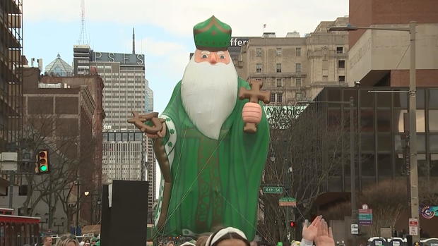 A giant balloon of St. Patrick floats down the parade route 