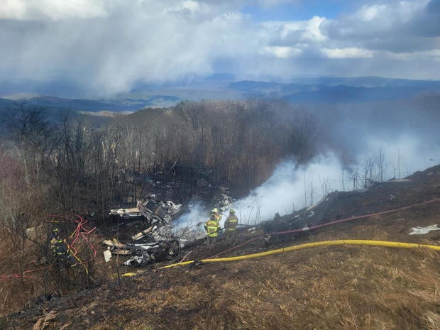 Emergency crew work at the site of a business jet crash in Hot springs 