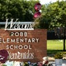Flowers and toys are placed outside the former Robb Elementary School in Uvalde, Texas, May 24, 2023. 