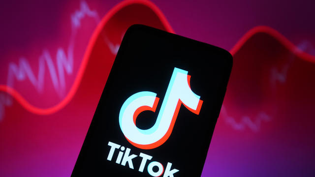 In this photo illustration, a TikTok logo is seen displayed 