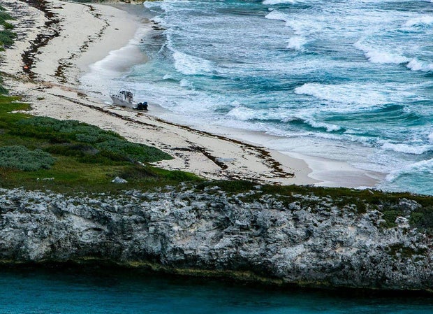 An abandoned vessel on a beach on a deserted island is seen during a U.S. Coast Guard reconnaissance flight on April 22, 2022, over the Florida Straits and the Bahamas.