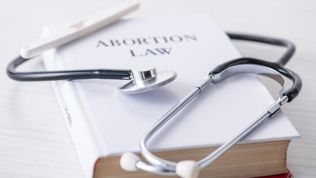 book with abortion law lettering 