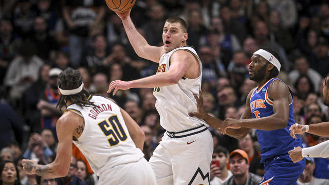 Nikola Jokic (15) of the Denver Nuggets looks up court before tossing up a full court shot to end the half against the New York Knicks during the second quarter at Ball Arena in Denver on Thursday, March 21, 2024. 