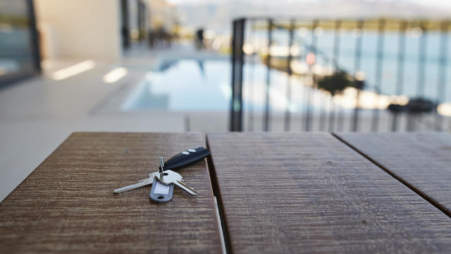 House keys against swimming pool 