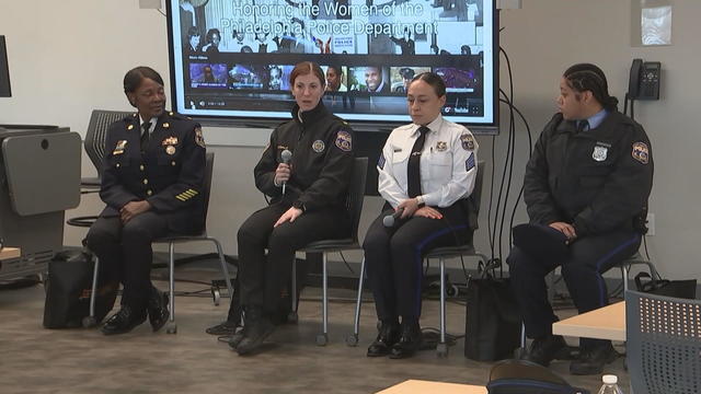 Four women police officers speak during a panel at the Community College of Philadelphia 