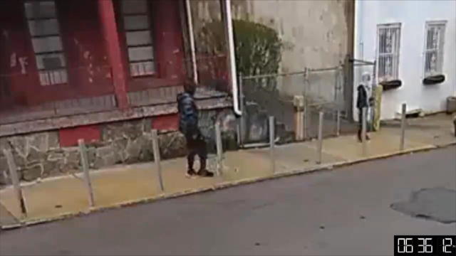 Surveillance video shows two people on a sidewalk in East Germantown 