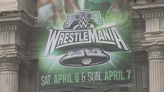 A WrestleMania sign hangs near City Hall in Philadelphia. It says Saturday April 6 and Sunday April 7. 