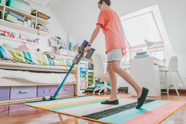 Teen cleaning bedroom