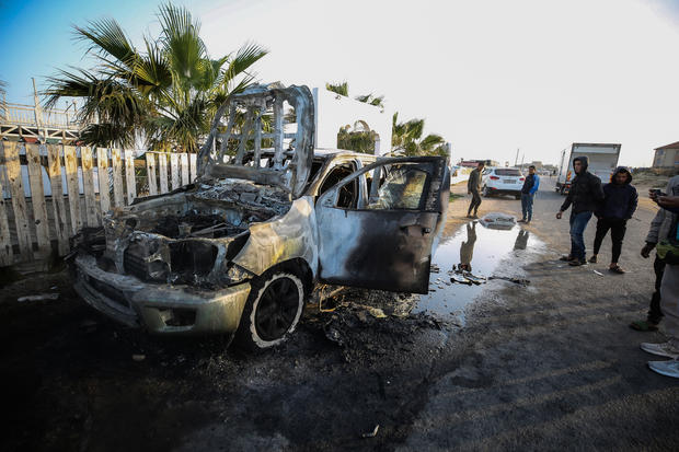 Palestinians stand next to a vehicle in Deir Al-Balah, in the central Gaza Strip, April 2, 2024, where employees from the World Central Kitchen were killed in an Israeli airstrike.World-Central-Kitchen-WCK-Aid-workers 