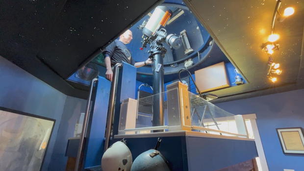 Peter Detterline stands inside his backyard observatory 
