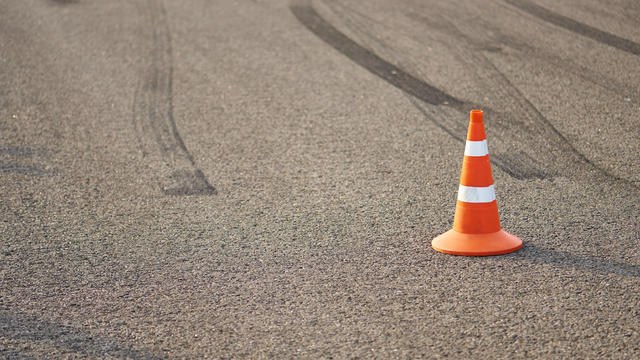 Orange traffic cone on a race track with copy space,Romania 