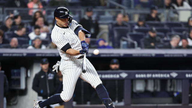 Giancarlo Stanton #27 of the New York Yankees hits a solo home run in the sixth inning against the Miami Marlins at Yankee Stadium on April 10, 2024 in the Bronx borough of New York City. 