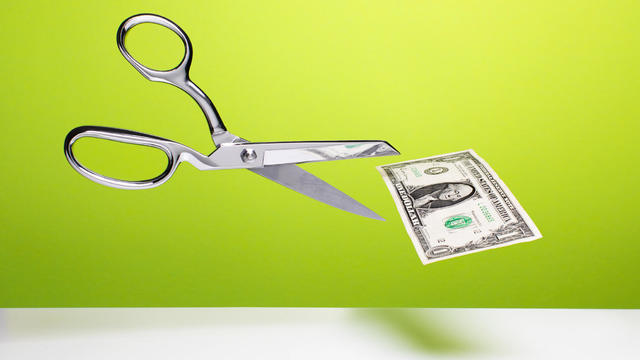 Cutting the budget - Scissors and dollar 