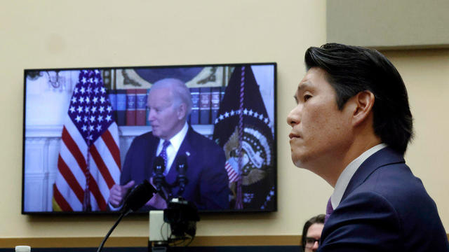 Former special counsel Robert Hur testifies as a video of President Biden plays before the House Judiciary Committee on March 12, 2024. 