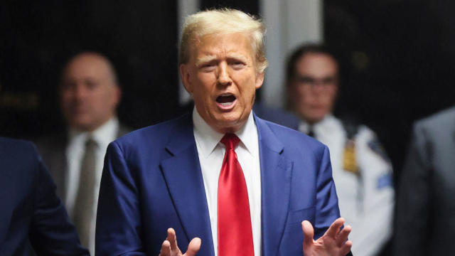 Former President Donald Trump speaks to members of the media in the hallway outside a courtroom at Manhattan Criminal Court in New York on Monday, March 25, 2024. 
