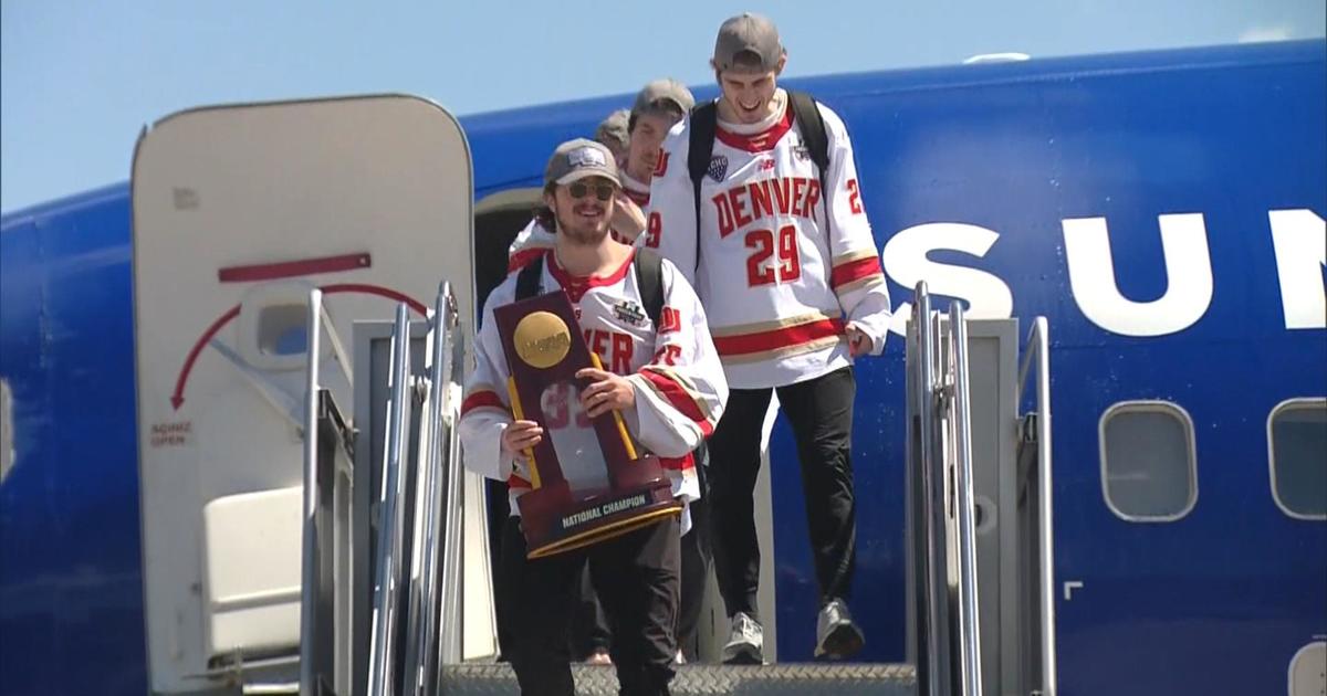 University of Denver men's hockey team ready to celebrate after returning home with national championship trophy: “First one through ten, so we have the belt now”