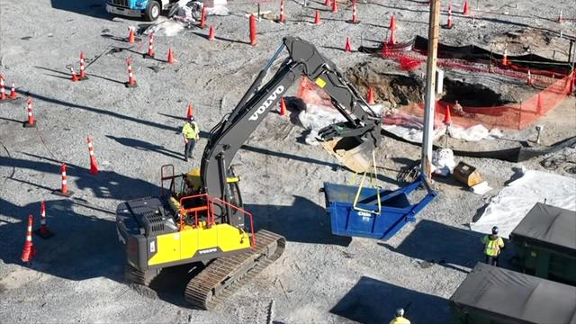 An aerial view of construction equipment digging in the former Grumman Aerospace site 