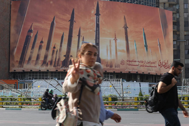 An anti-Israel billboard with a picture of Iranian missiles is seen in a street in Tehran 