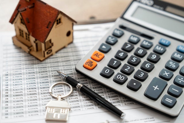 House model and calculator on table for finance ,selling home concept., bangking concept 