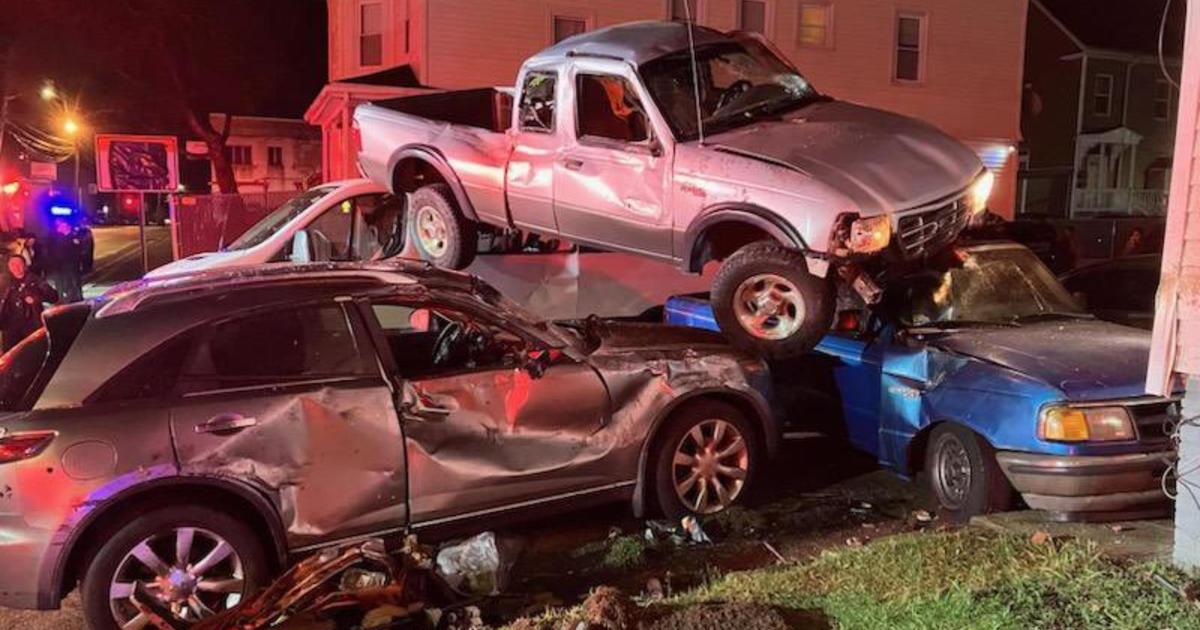 Pickup truck lands on top of cars in Brockton crash; driver flees scene – CBS Boston