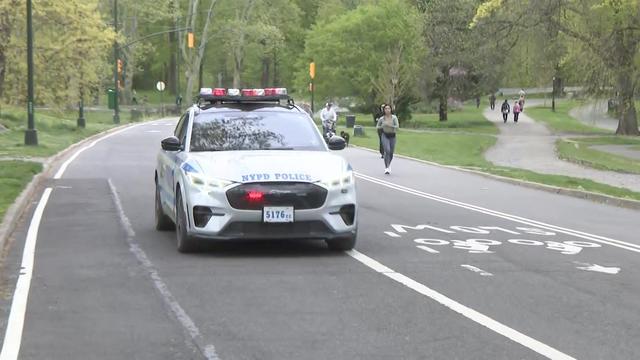 An NYPD vehicle drives through Central Park. 