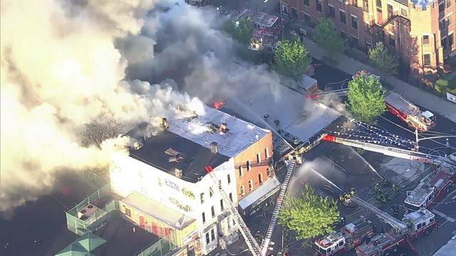 An overhead view of smoke billowing out of multiple buildings in Brooklyn. 