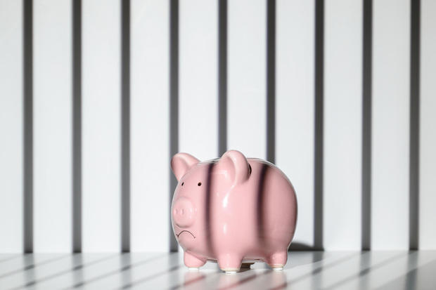 Piggy bank trapped inside a prison 