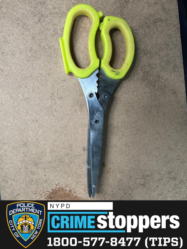 A pair of scissors with lime green handles. 