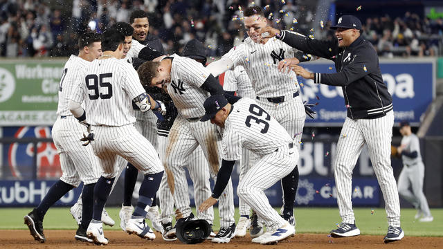 Anthony Rizzo #48 of the New York Yankees is mobbed by his teammates after his ninth inning game winning base hit against the Detroit Tigers at Yankee Stadium on May 03, 2024 in New York City. 