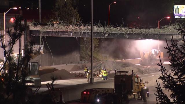 Crews work at night to demolish an overpass over I-95. 