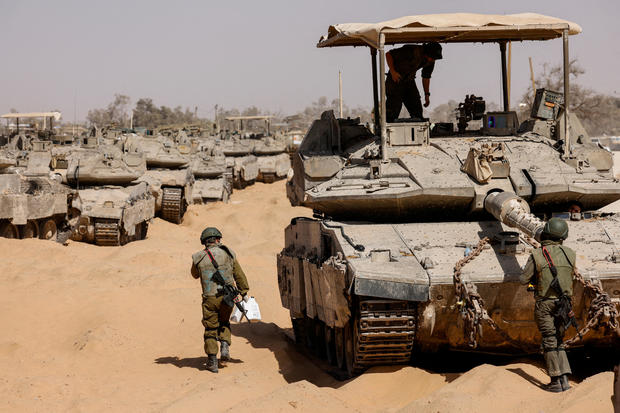 Israeli military vehicles are parked near the Israel-Gaza border 