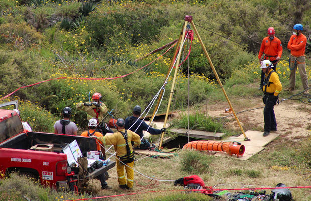 FILE PHOTO: Members of a rescue team work at a site where three bodies were found, in La Bocana 