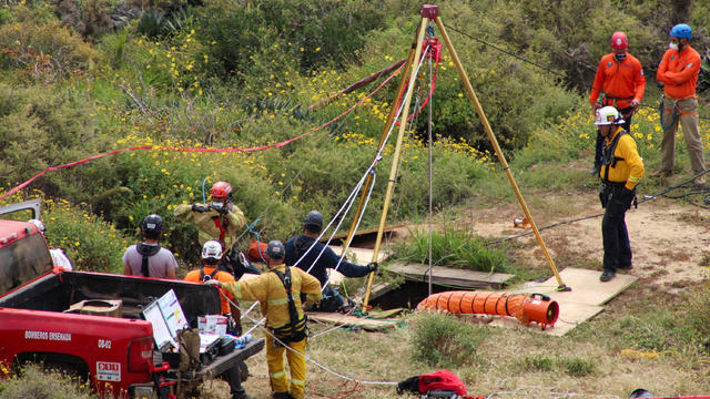 FILE PHOTO: Members of a rescue team work at a site where three bodies were found, in La Bocana 