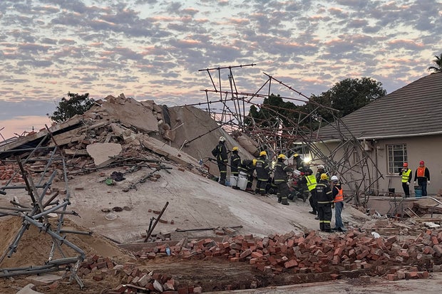 Rescue workers at the scene of a collapsed building in George, South Africa, May 7, 2024
