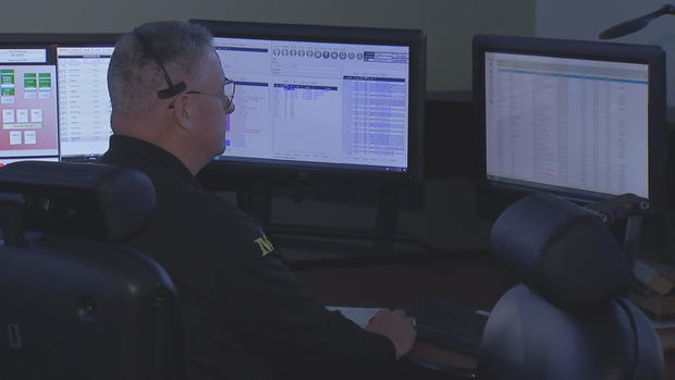 Brian Hathaway at his desk during a shift as a Temple University Police dispatcher 