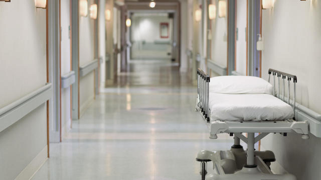 Portable hospital bed in hallway 